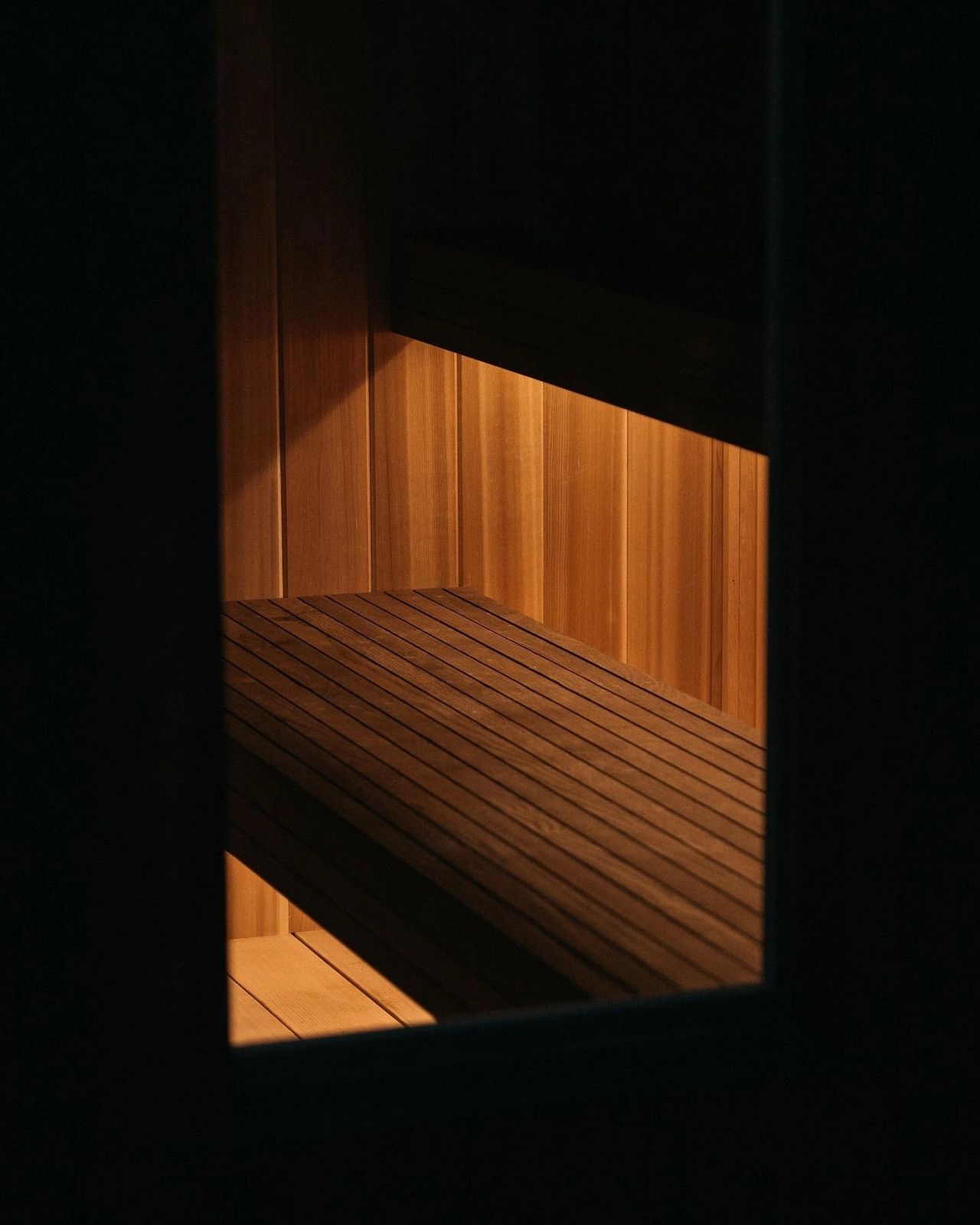 A glowing bench in a dark sauna